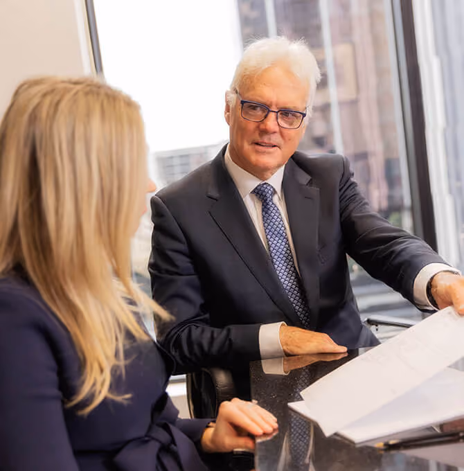 Peter Carew, our founder, discussing court representation strategies with our lawyers at our Melbourne offices.