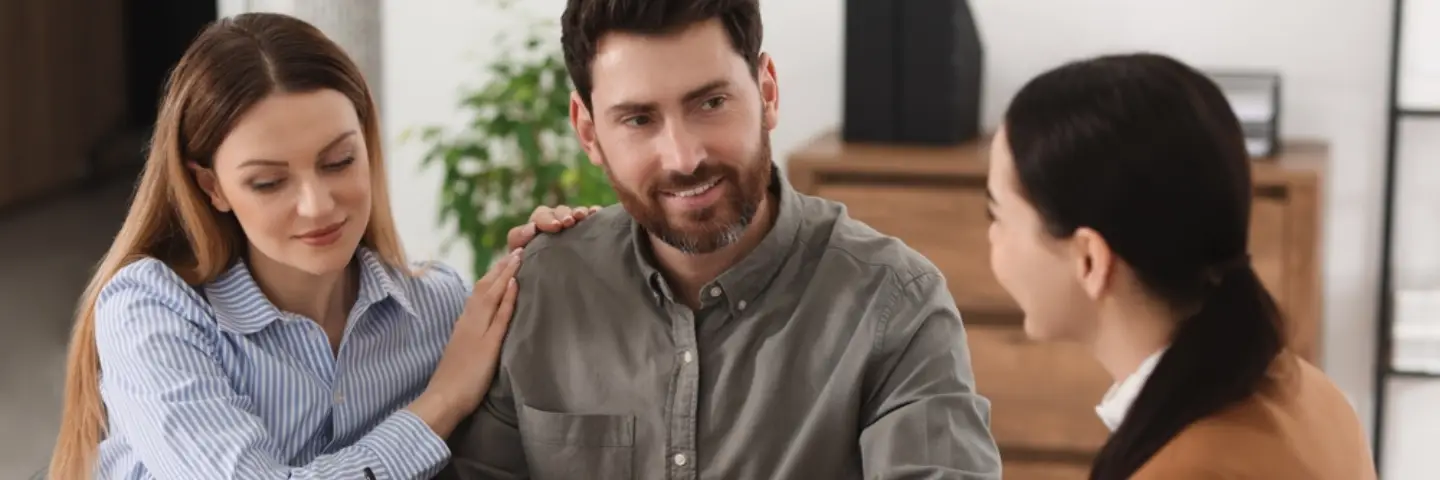 Lawyer discussing legal documents with a client in an office meeting.