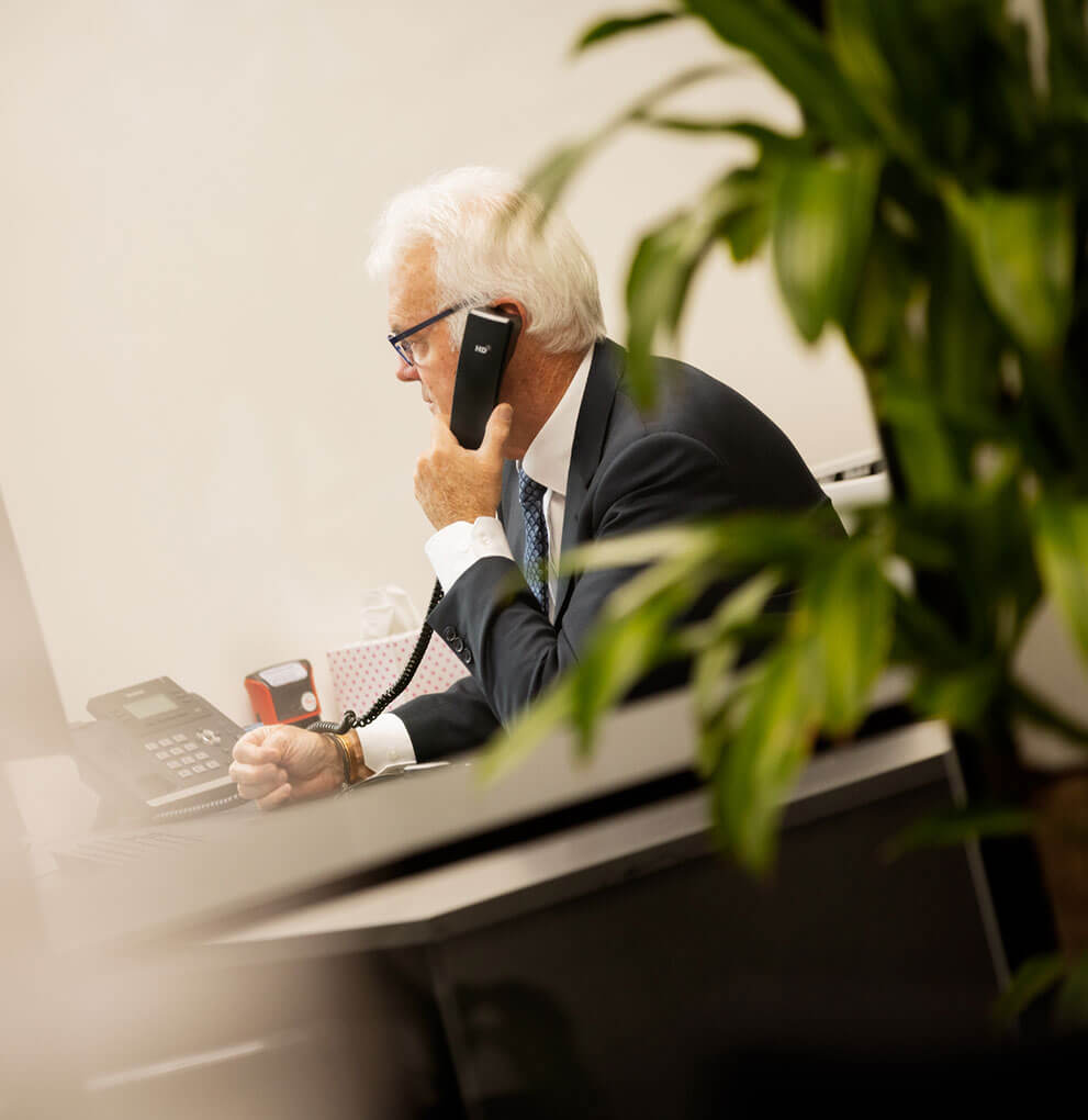 Carew Counsel Solicitors staff in meeting with client at meeting table