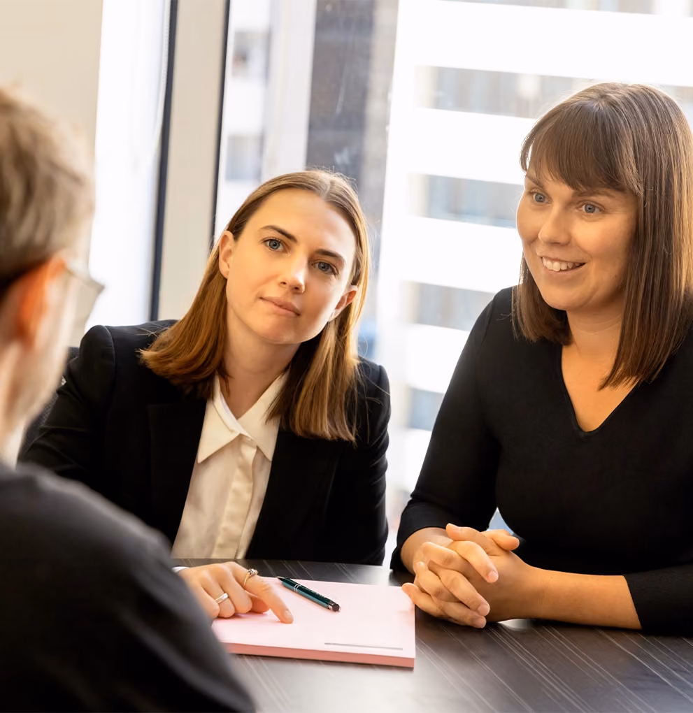 Two of our Melbourne child support lawyers in a consultation with a client at our offices.
