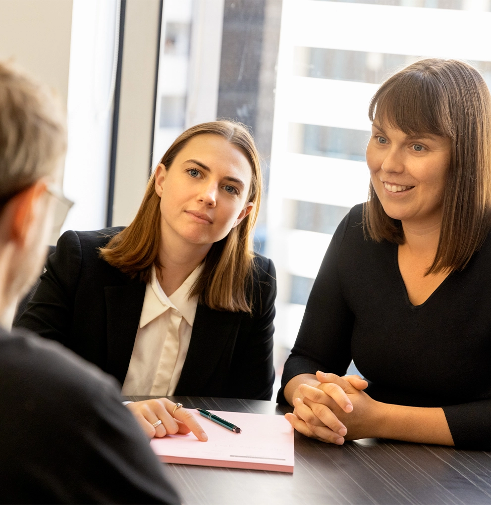 Two of our Melbourne family law mediation lawyers in a consultation with a client at our offices.