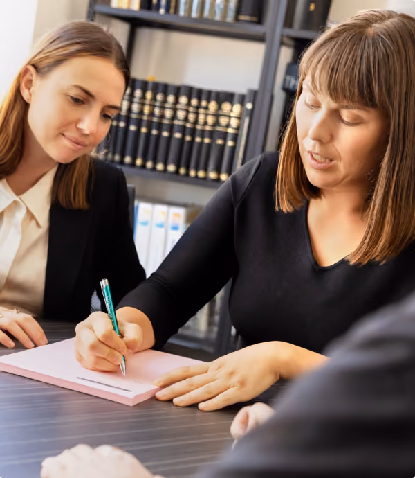 Two of our Melbourne prenup lawyers reviewing prenup documents with a client at our offices.