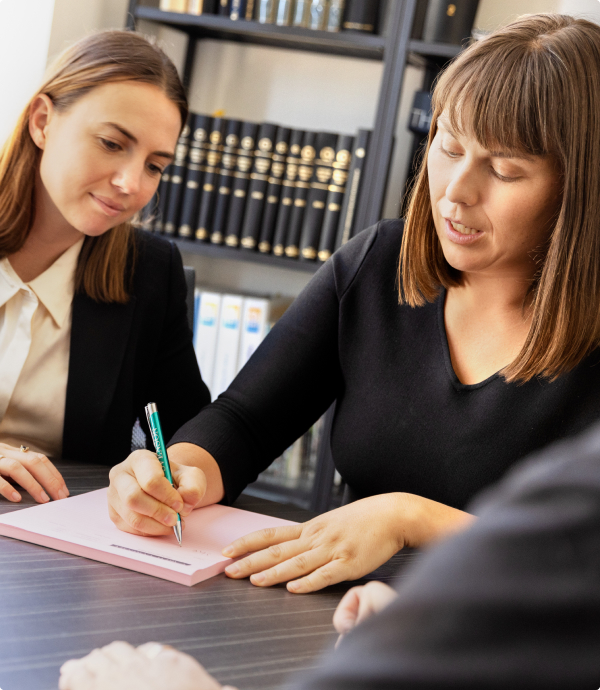 Carew Counsel Solicitors staff in meeting with client at meeting table