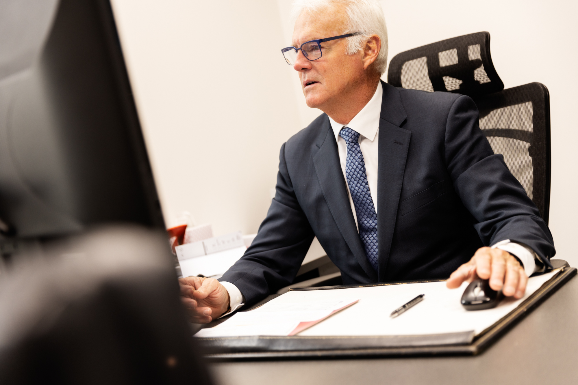 Peter Carew, our founder and family lawyer, reviewing documents for a client we’re representing in court in Victoria.