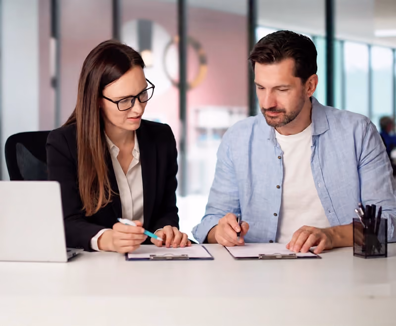 Professional individual reviewing financial documents during a divorce planning consultation with a family lawyer.