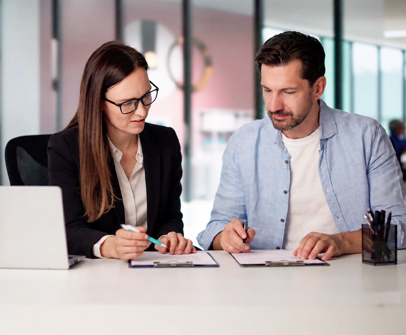 Professional individual reviewing financial documents during a divorce planning consultation with a family lawyer.