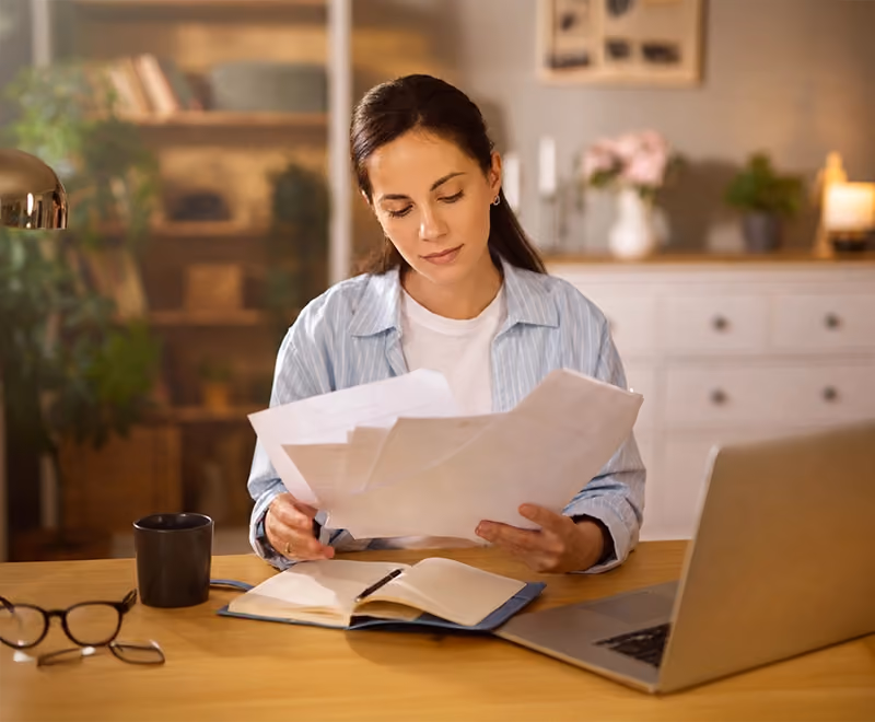Professional individual reviewing documents in a calm setting while considering divorce application
