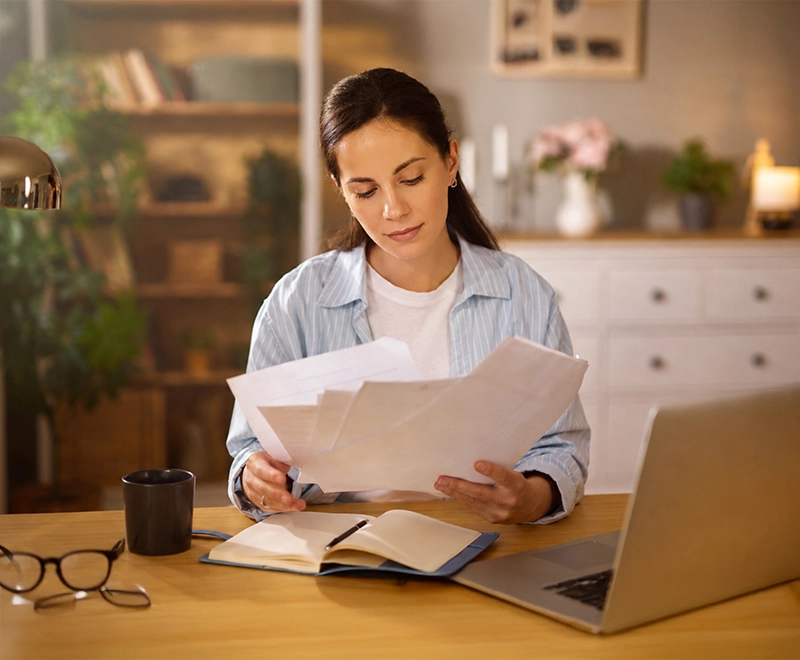 Professional individual reviewing documents in a calm setting while considering divorce application