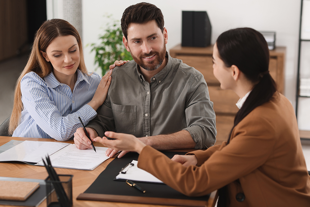 Lawyer discussing legal documents with a client in an office meeting.
