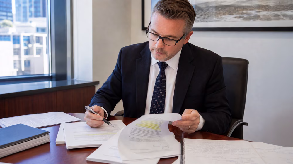 Lawyer reviewing legally compliant financial agreement documents in Australia.