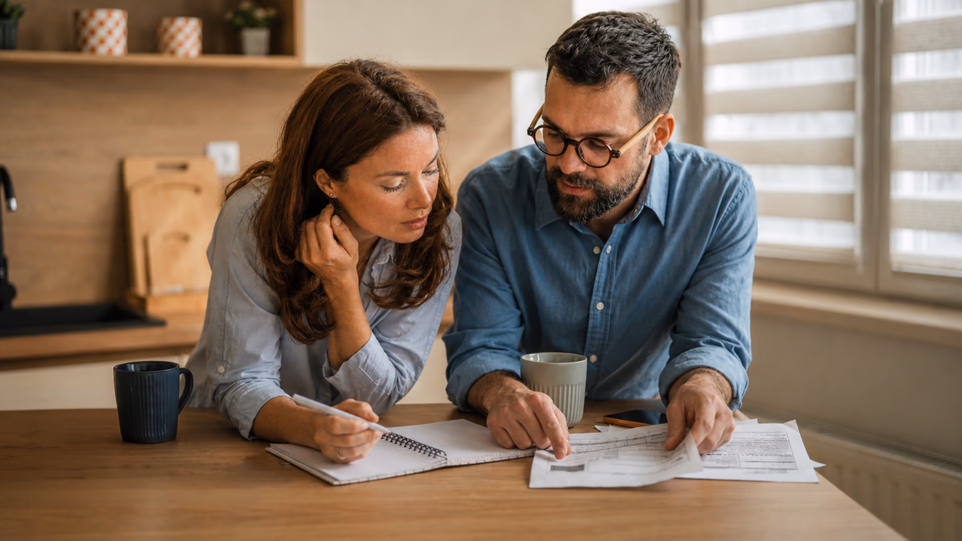 Couple reviewing estate planning documents at home