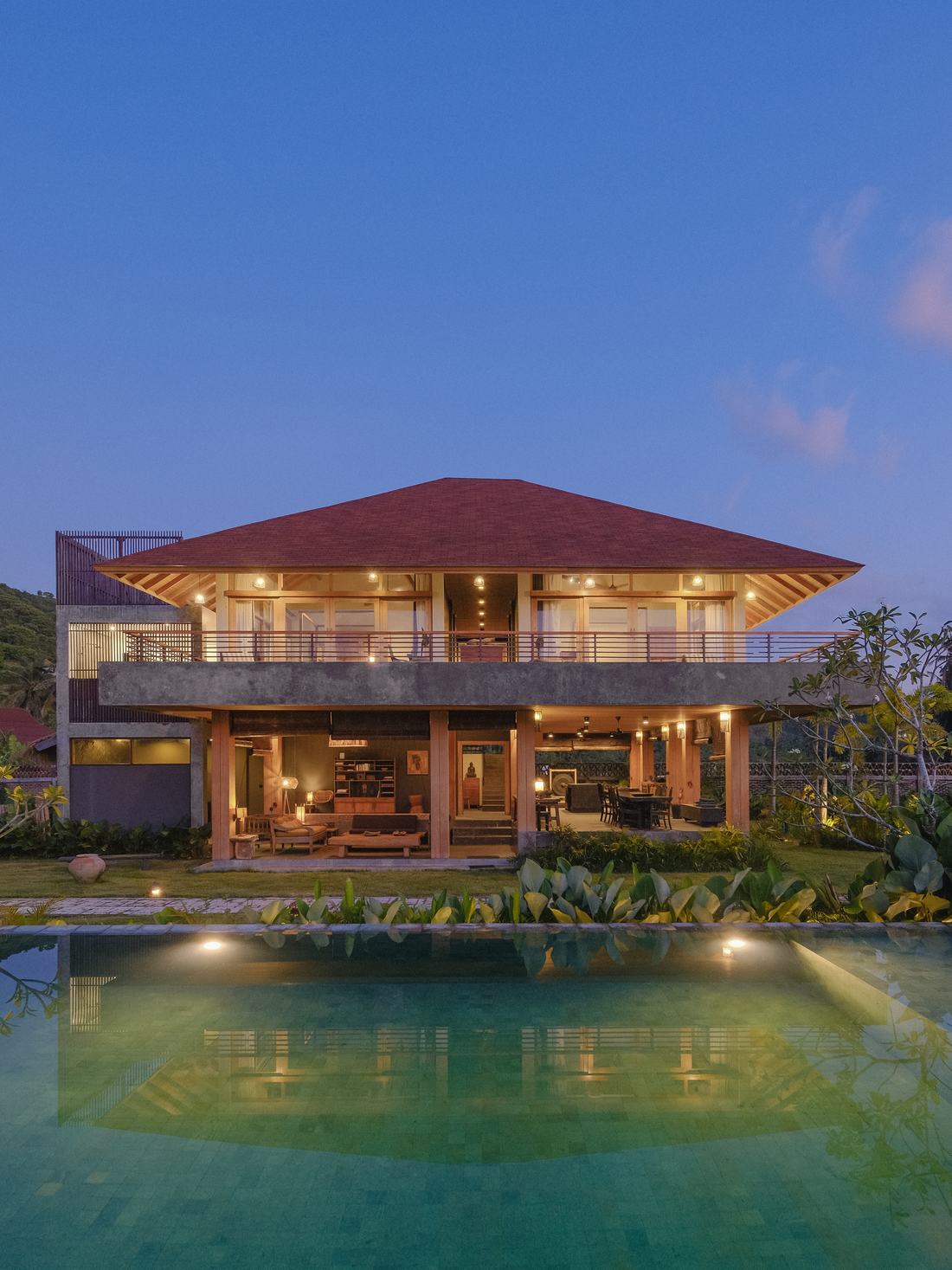the villa lit at dusk
