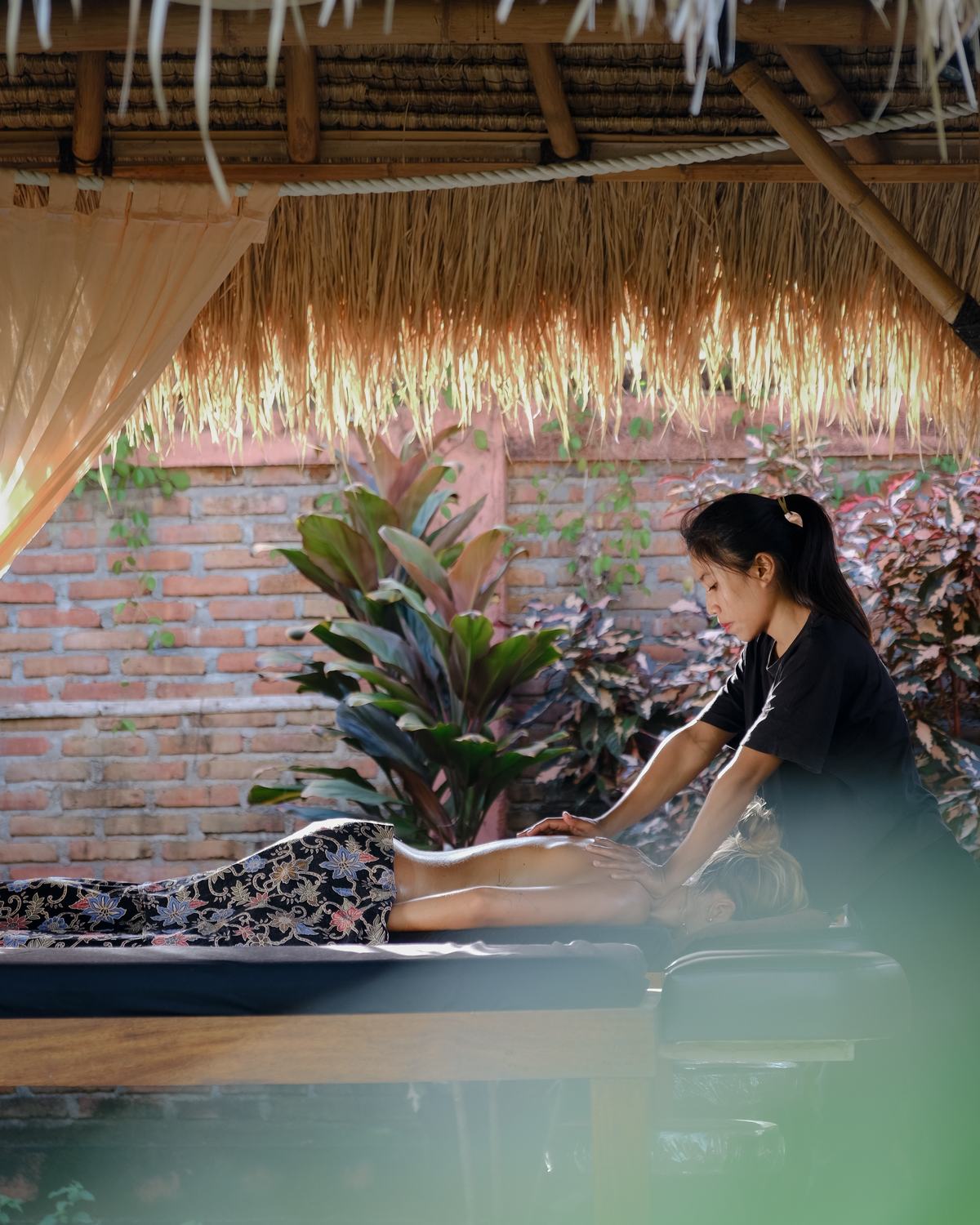a massage under the thatch by the water
