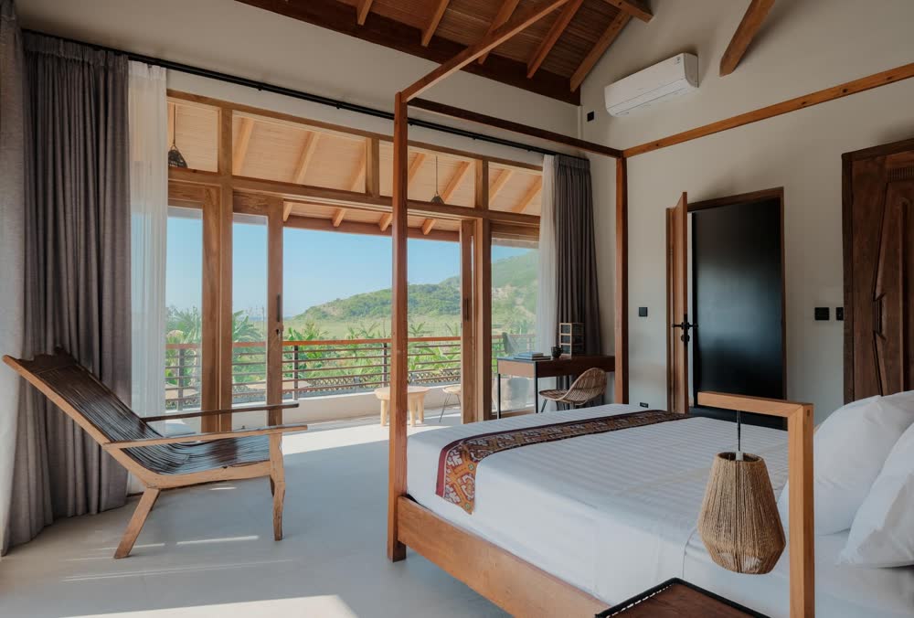 a bedroom that opens to the view