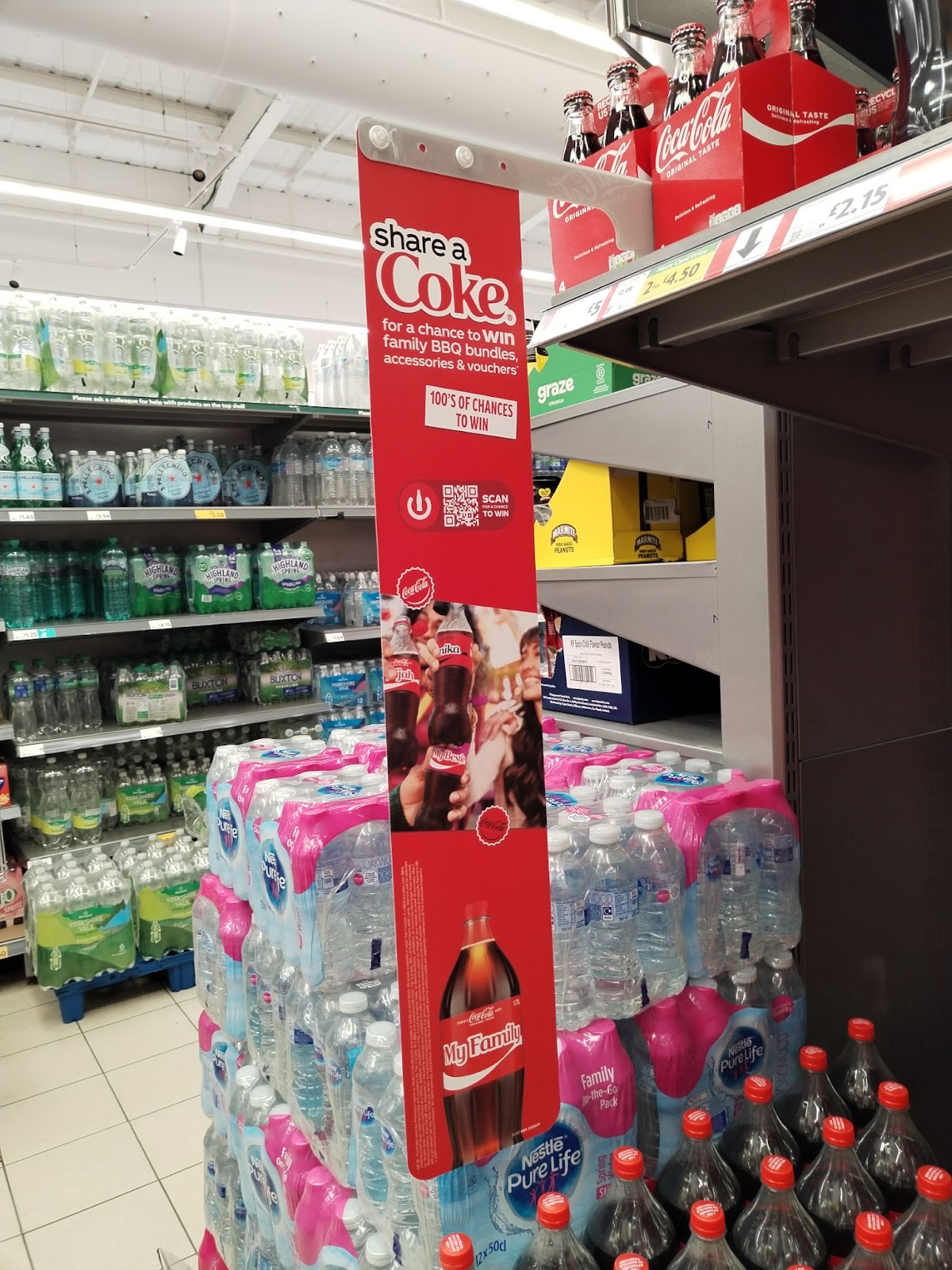 Coca-Cola aisle-fin hanging from shelf.