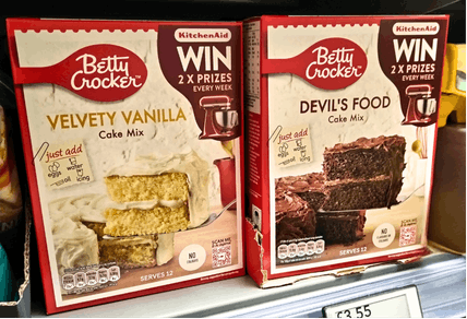 Promotional-packs of Betty Crocker's cake mixes on-shelf.