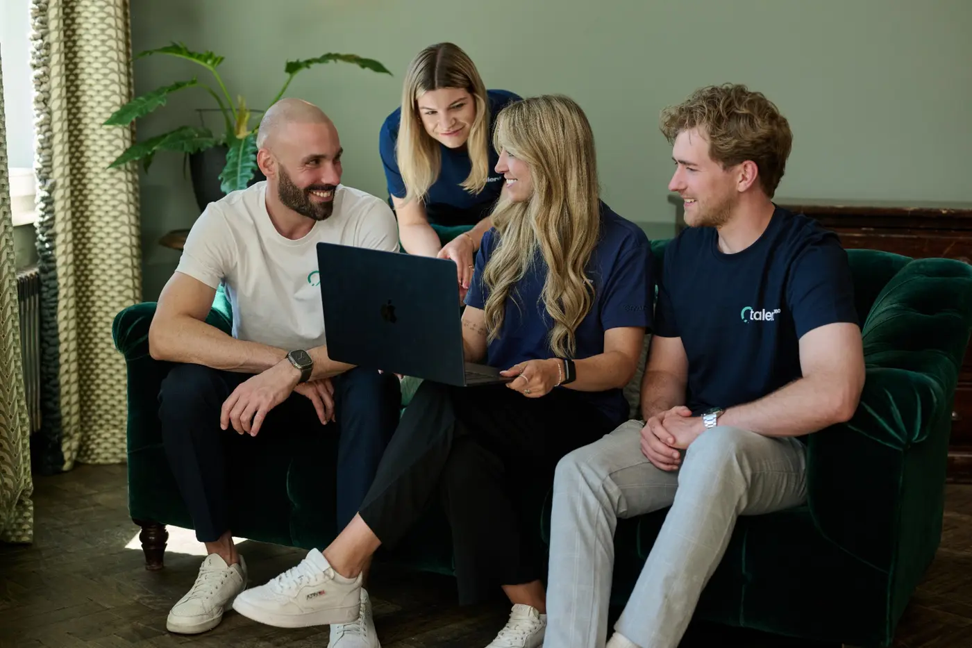 Das talent360 Team bespricht gemeinsam Recruiting-Prozesse am Laptop.