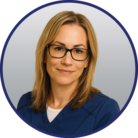 Professional headshot of long Kristy Carroll, wearing navy blue scrubs, posed against a gray gradient background with a navy circular border.