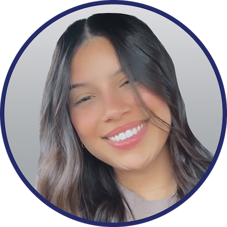 Professional headshot of Karina Vicente, wearing a tan blouse, posed against a gray gradient background with a navy circular border.