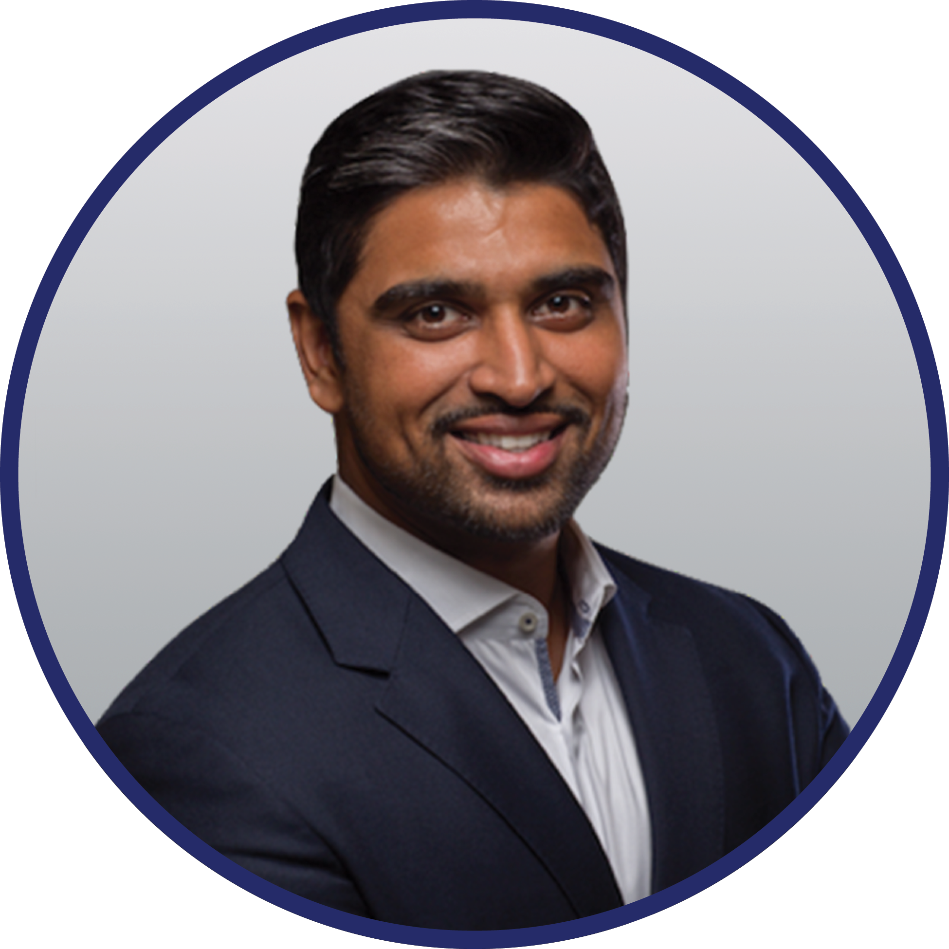 Headshot of Susan Coatar, a Caucasian woman with medium-length brown hair and a gentle smile, wearing a dark blue blazer, set against a grey background.