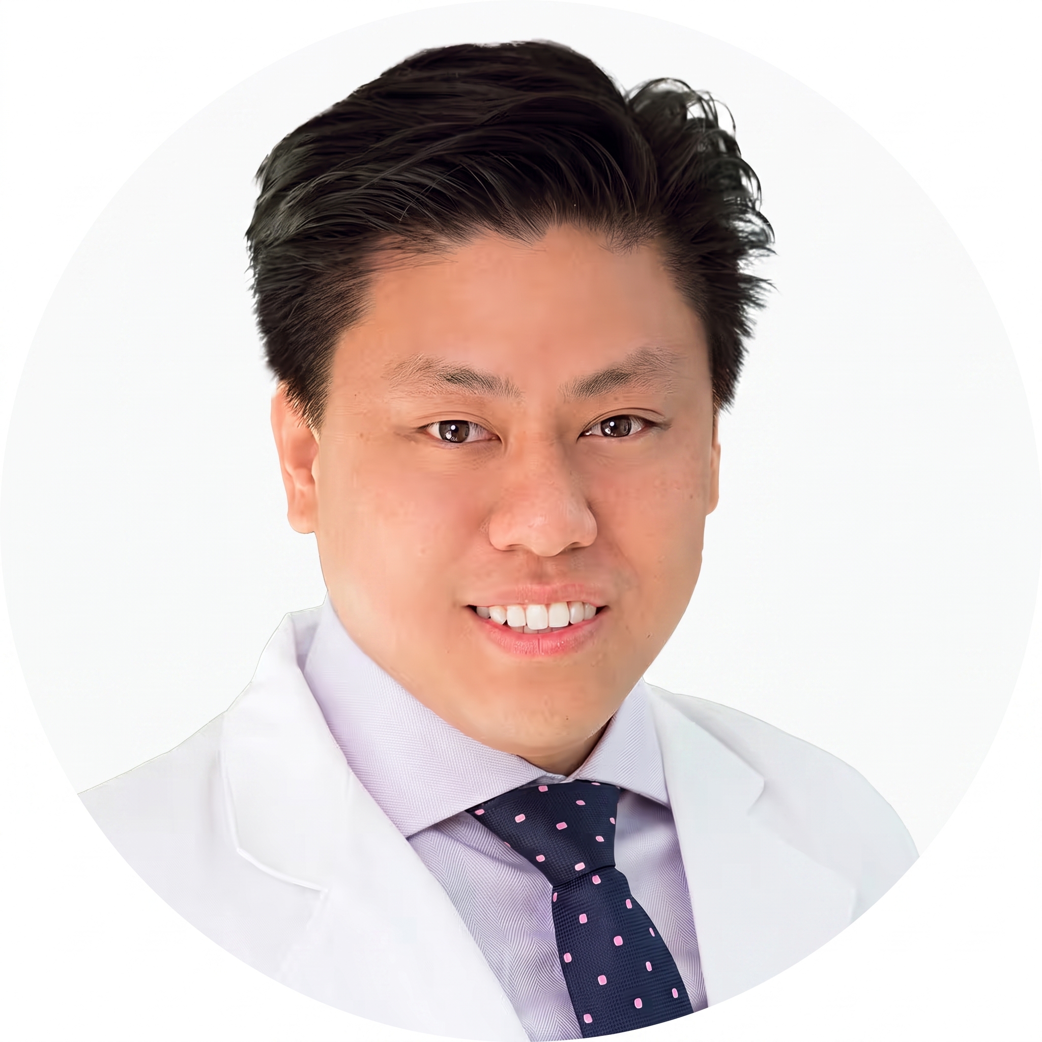 Dr. Jeronimo Lopez, M.D., a mature man with short gray hair, wearing a white medical coat with a stethoscope and a light blue and white button up