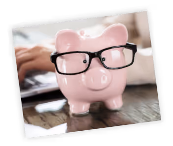 A pink piggy bank with glasses on top of it