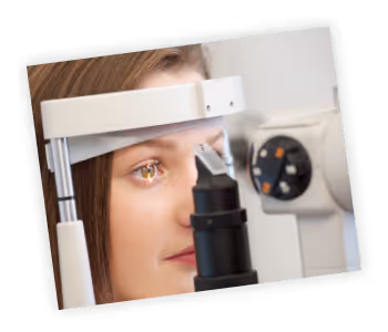A woman looking through a microscope at a clock