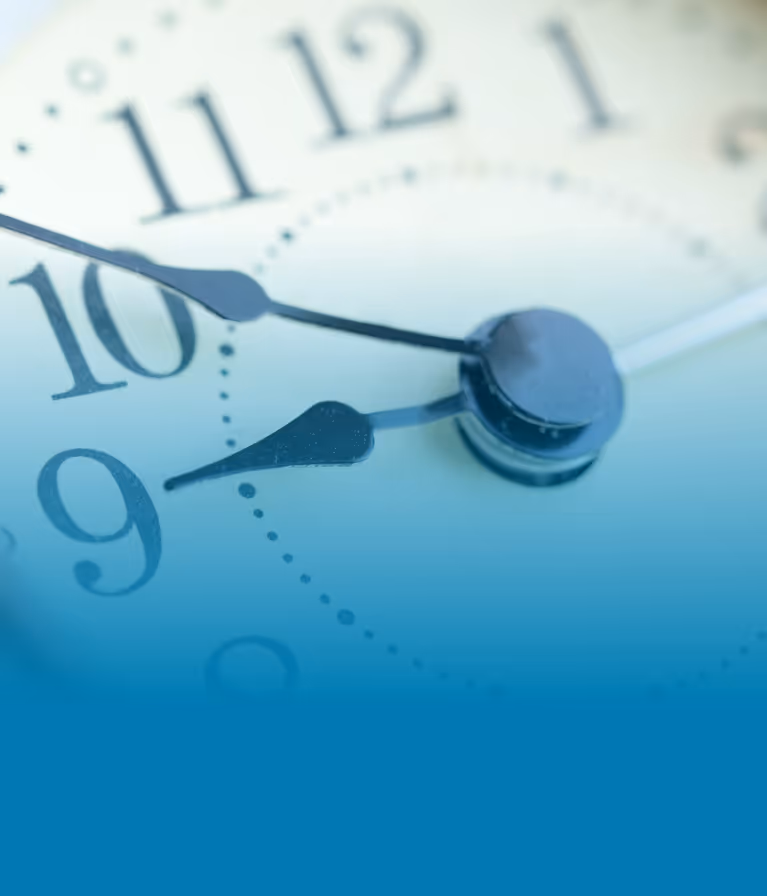 A close up of a clock with a blue background