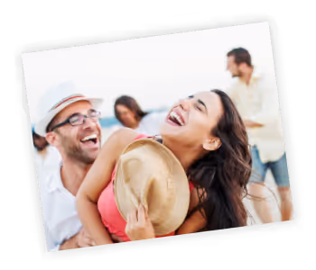 A man and a woman laughing together on the beach