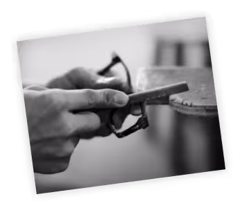 A black and white photo of a person holding a pair of scissors