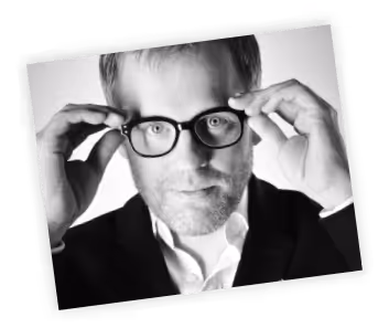 A black and white photo of a man wearing glasses