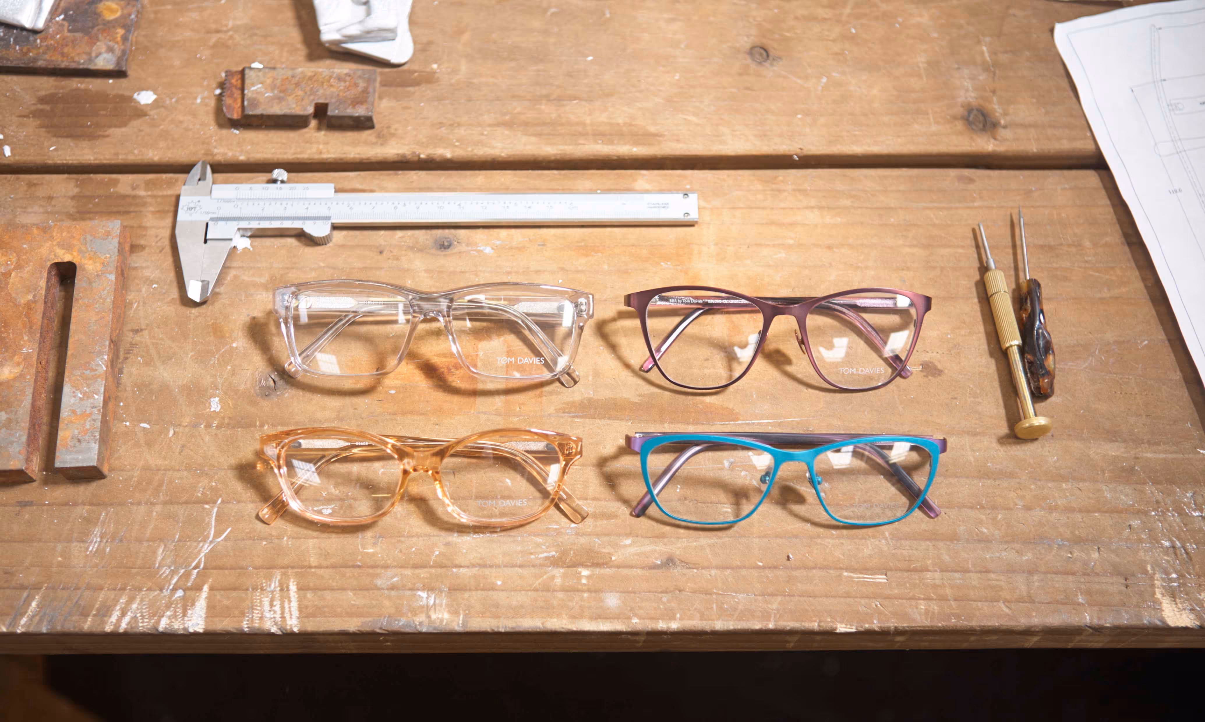 A wooden table topped with glasses and a gun