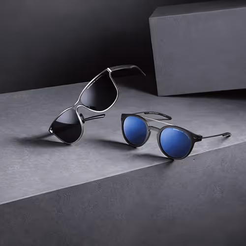 A pair of porsche design sunglasses sitting on top of a table
