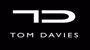 A black and white logo with the words tom davis