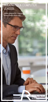 A man sitting at a desk using a laptop computer