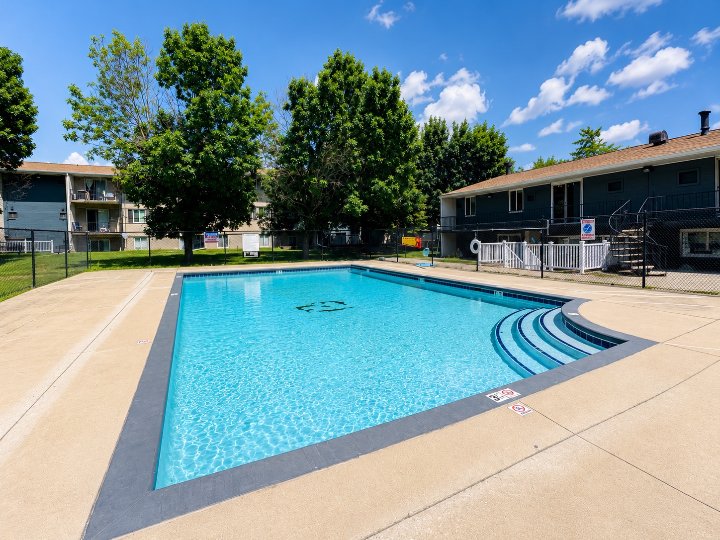 pool deck and large swimming pool with steps