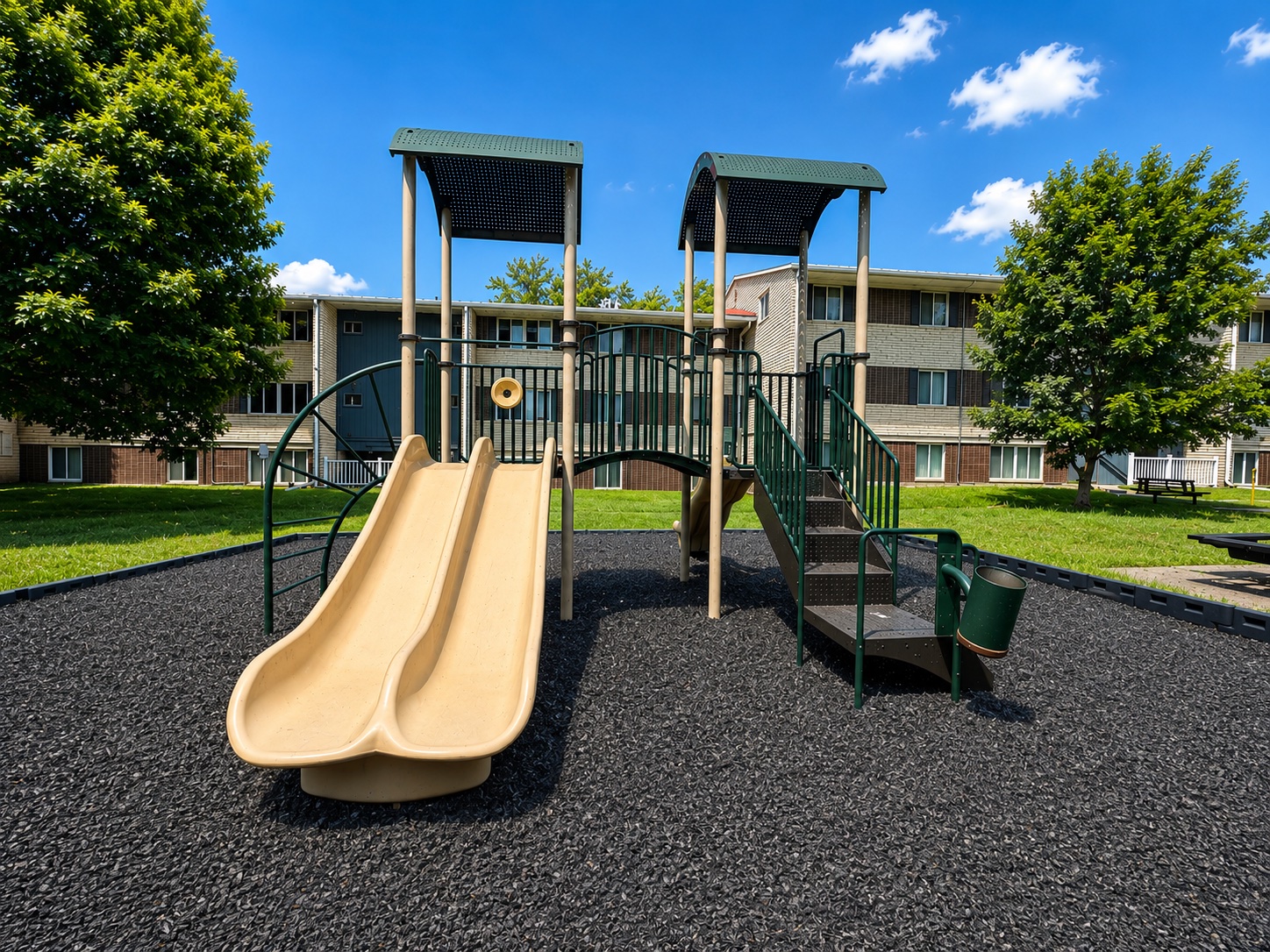 shade covered playground with slide