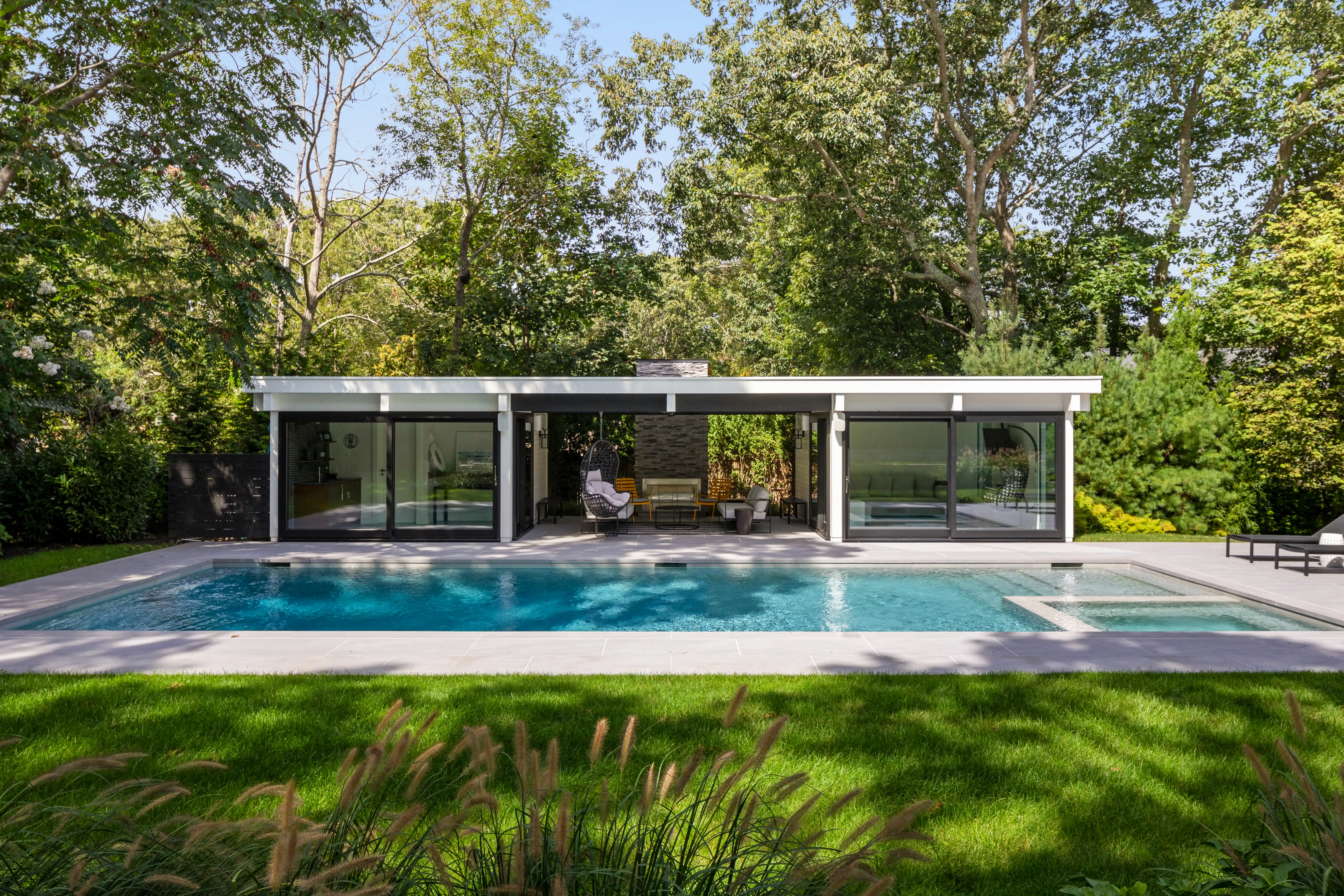 Modern luxury pool house with contemporary outdoor living and swimming pool