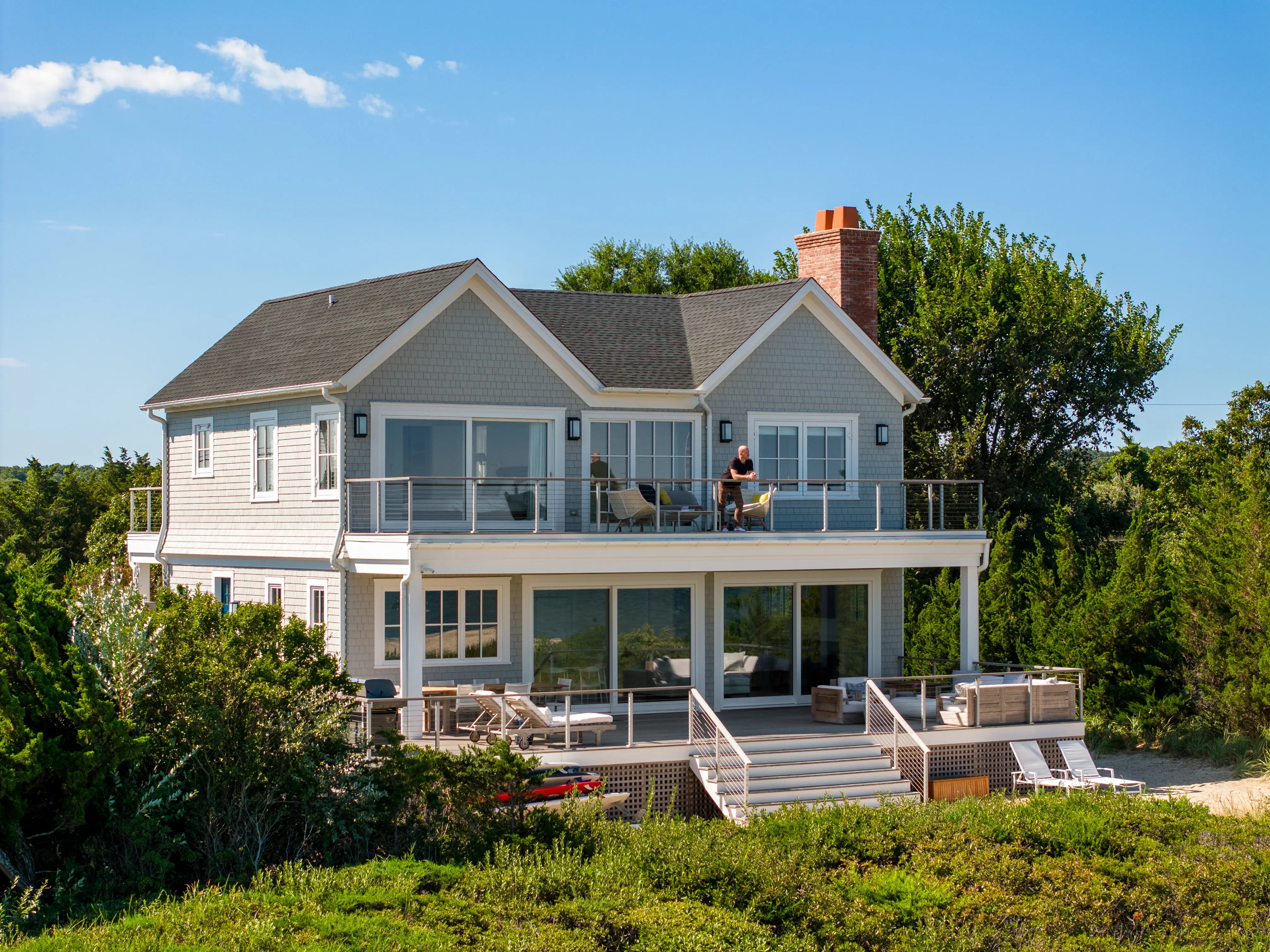 Luxury coastal custom home with elevated outdoor deck
