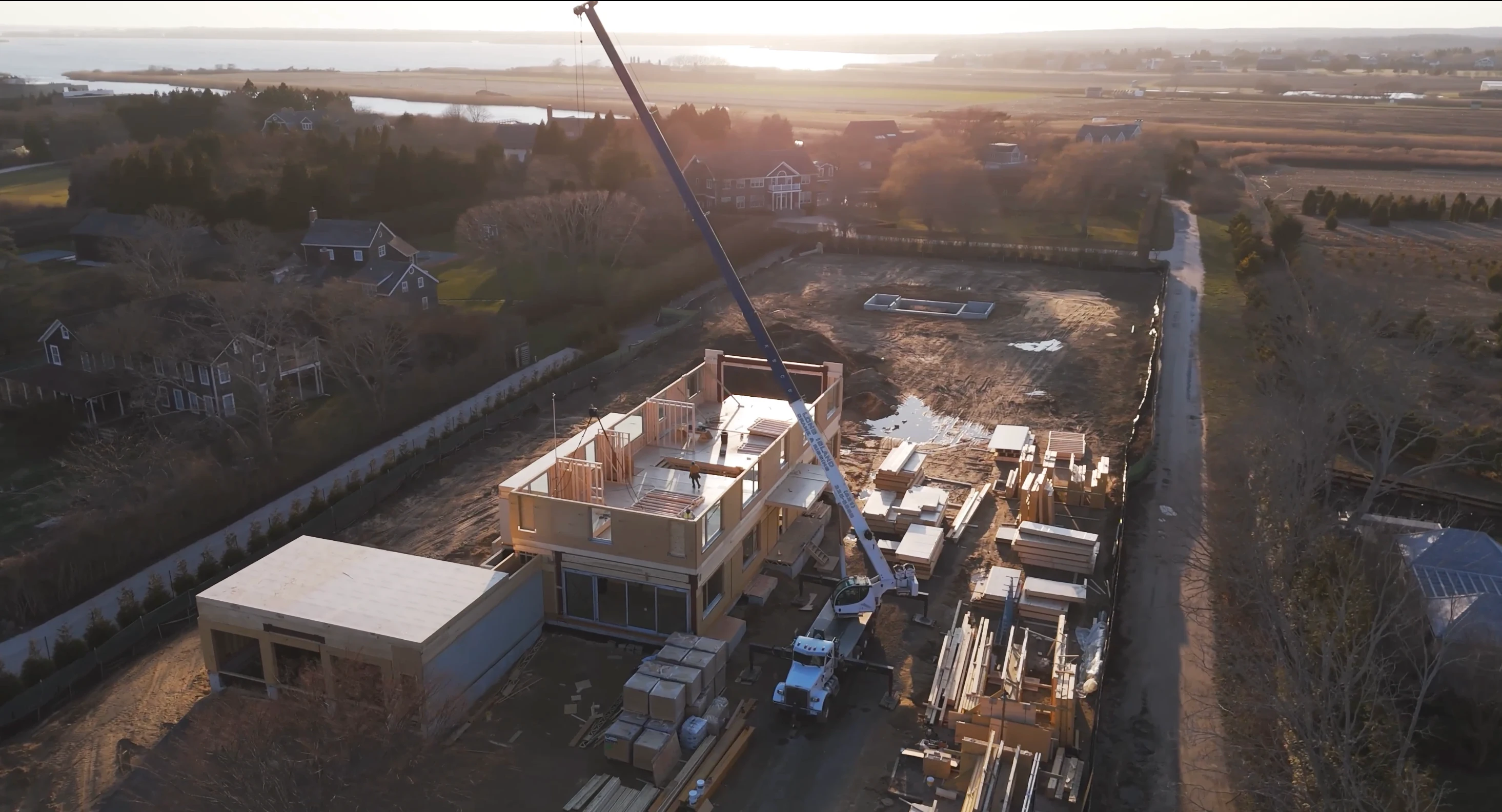Mass timber construction project with crane installation at coastal site
