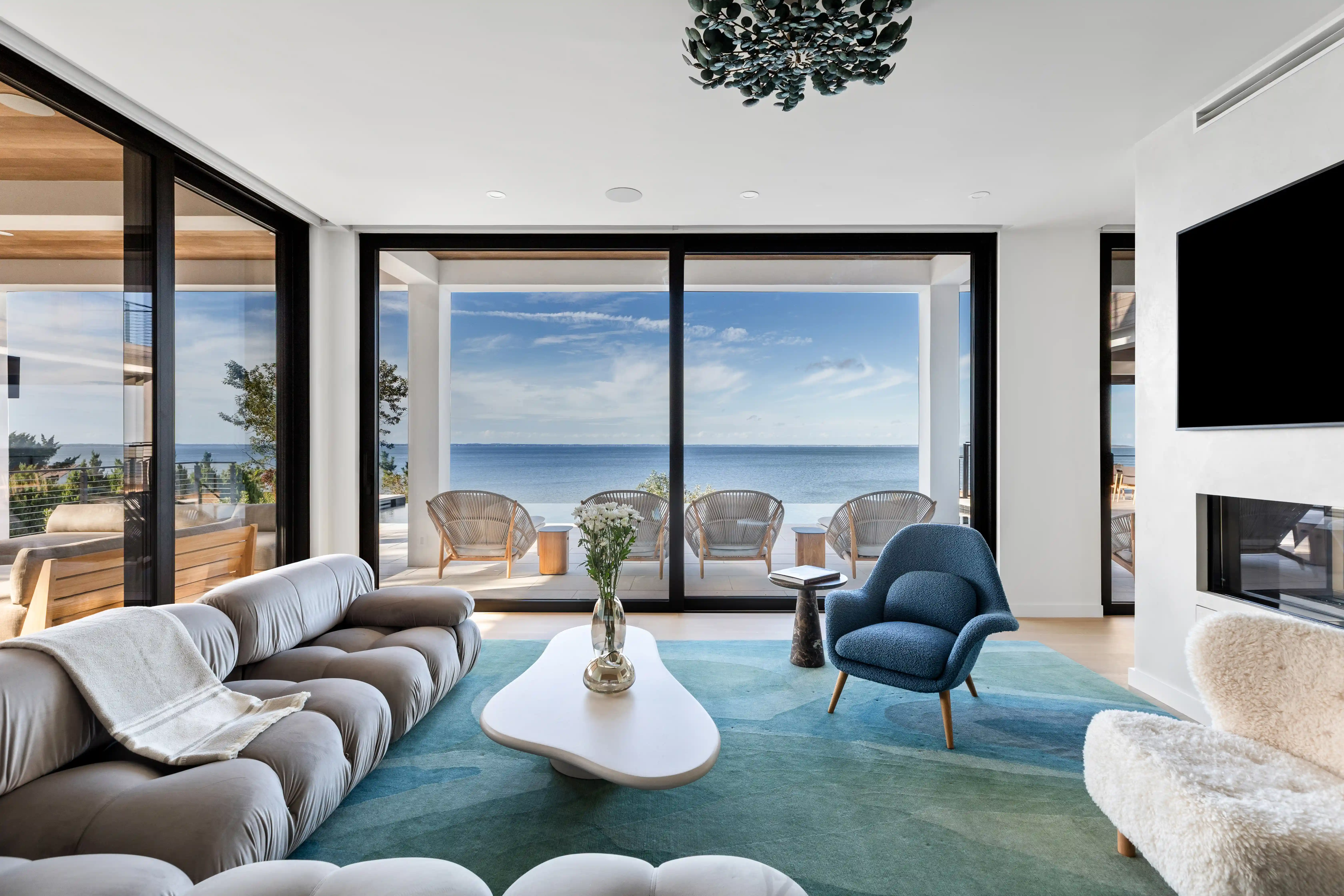 Luxury residential interior with modern furniture and waterfront balcony