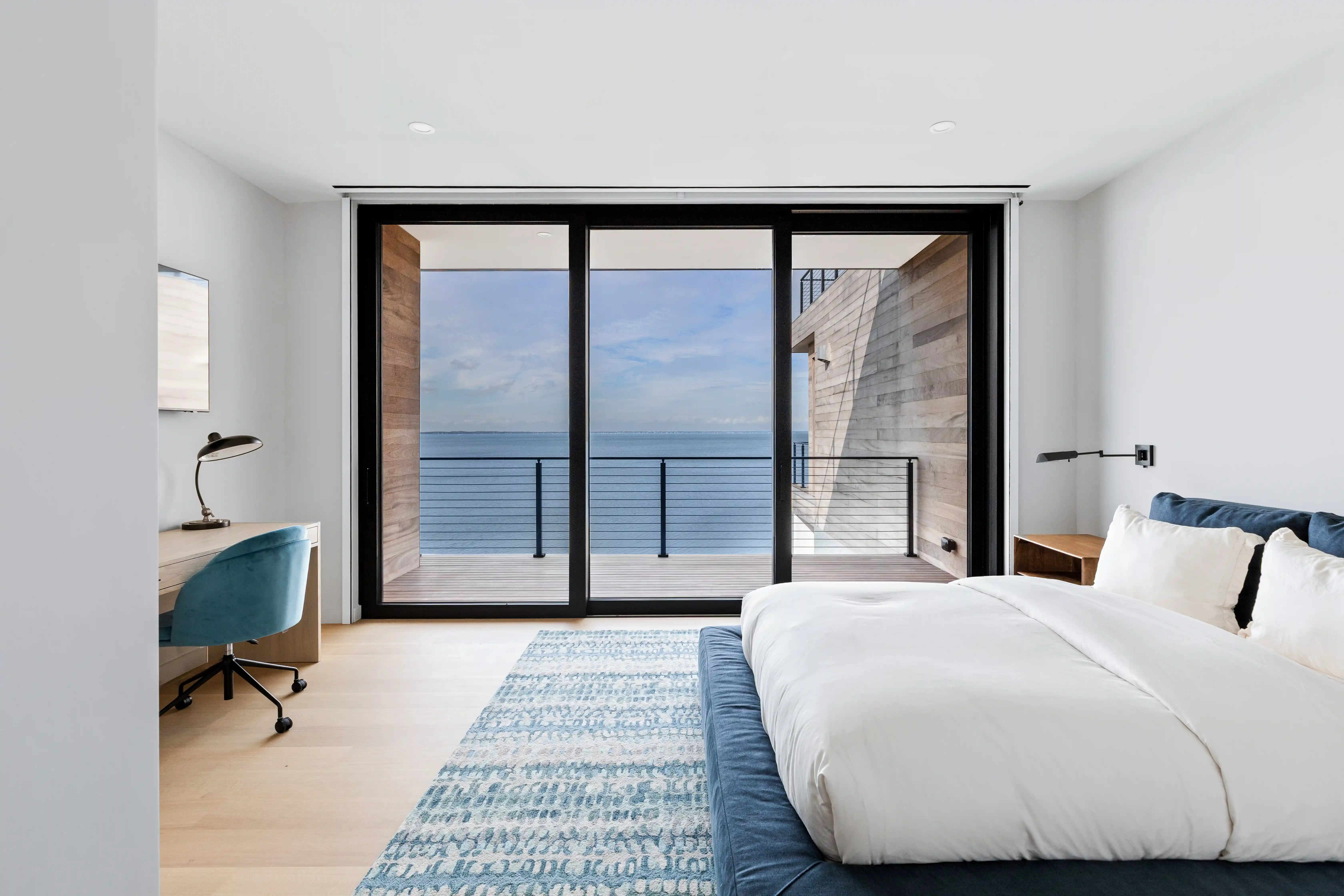 luxury bedroom overlooking oceanfront landscape and outdoor terrace