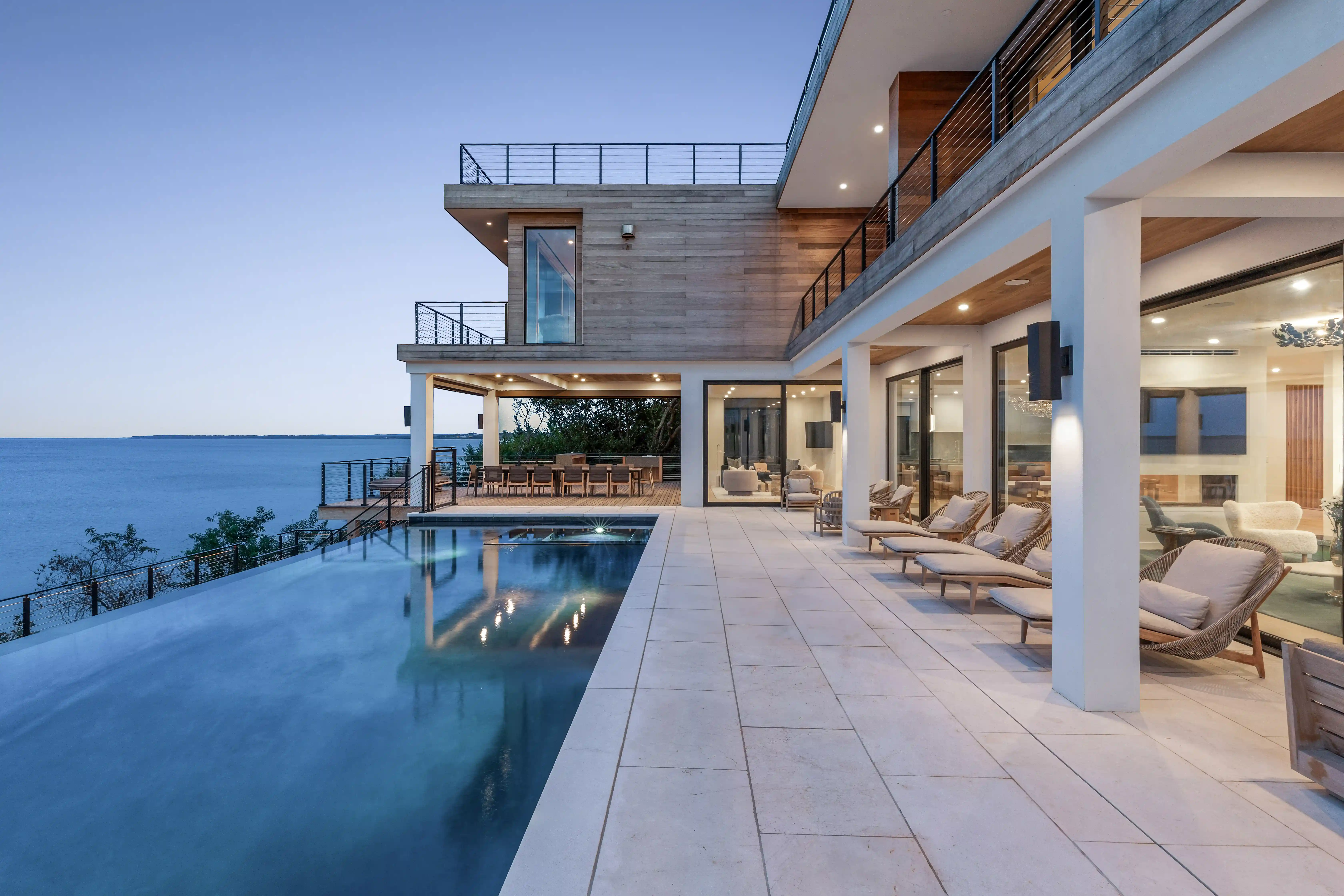 Luxury infinity pool with modern waterfront home