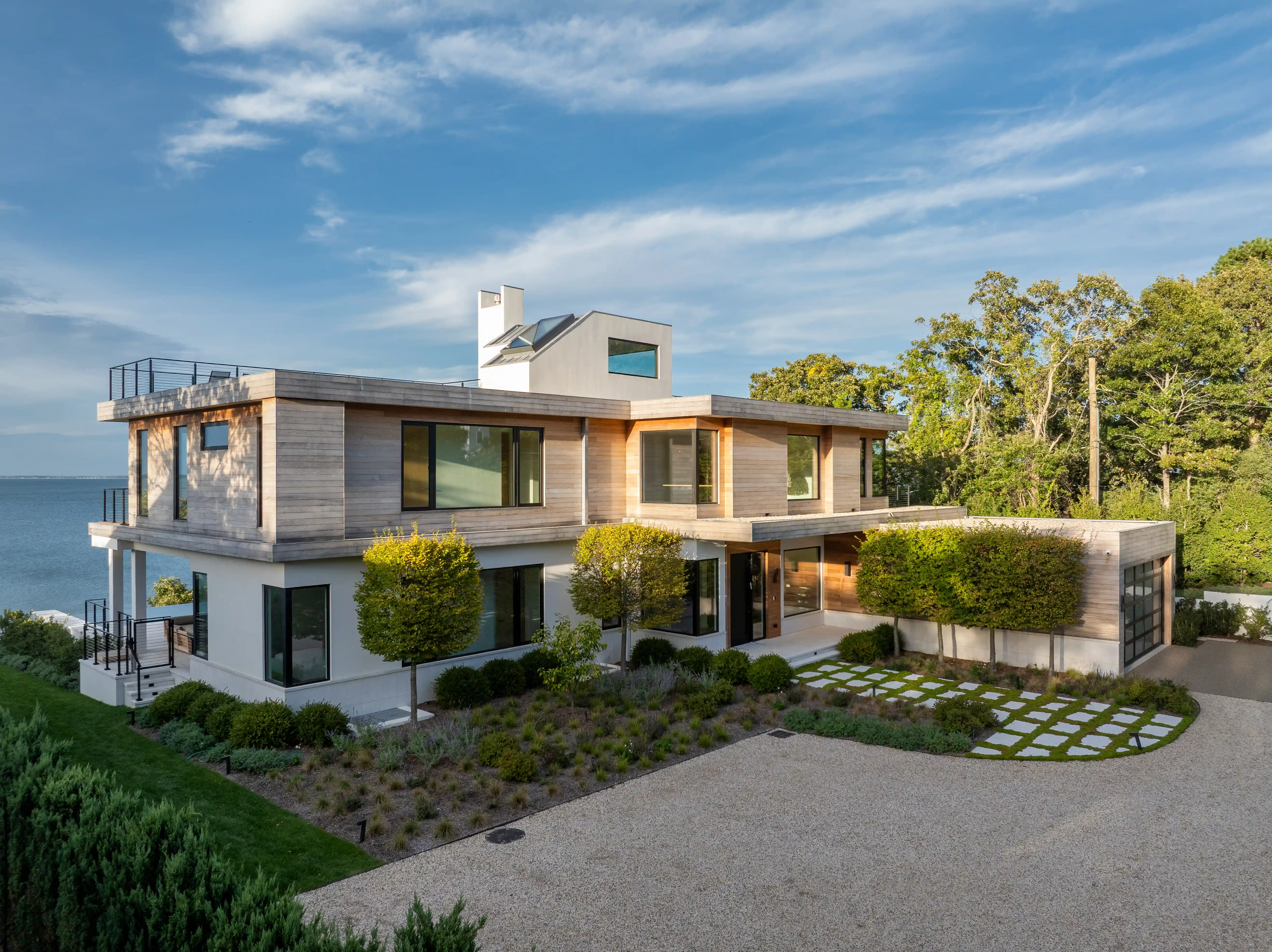 Modern waterfront luxury home exterior with contemporary architectural design