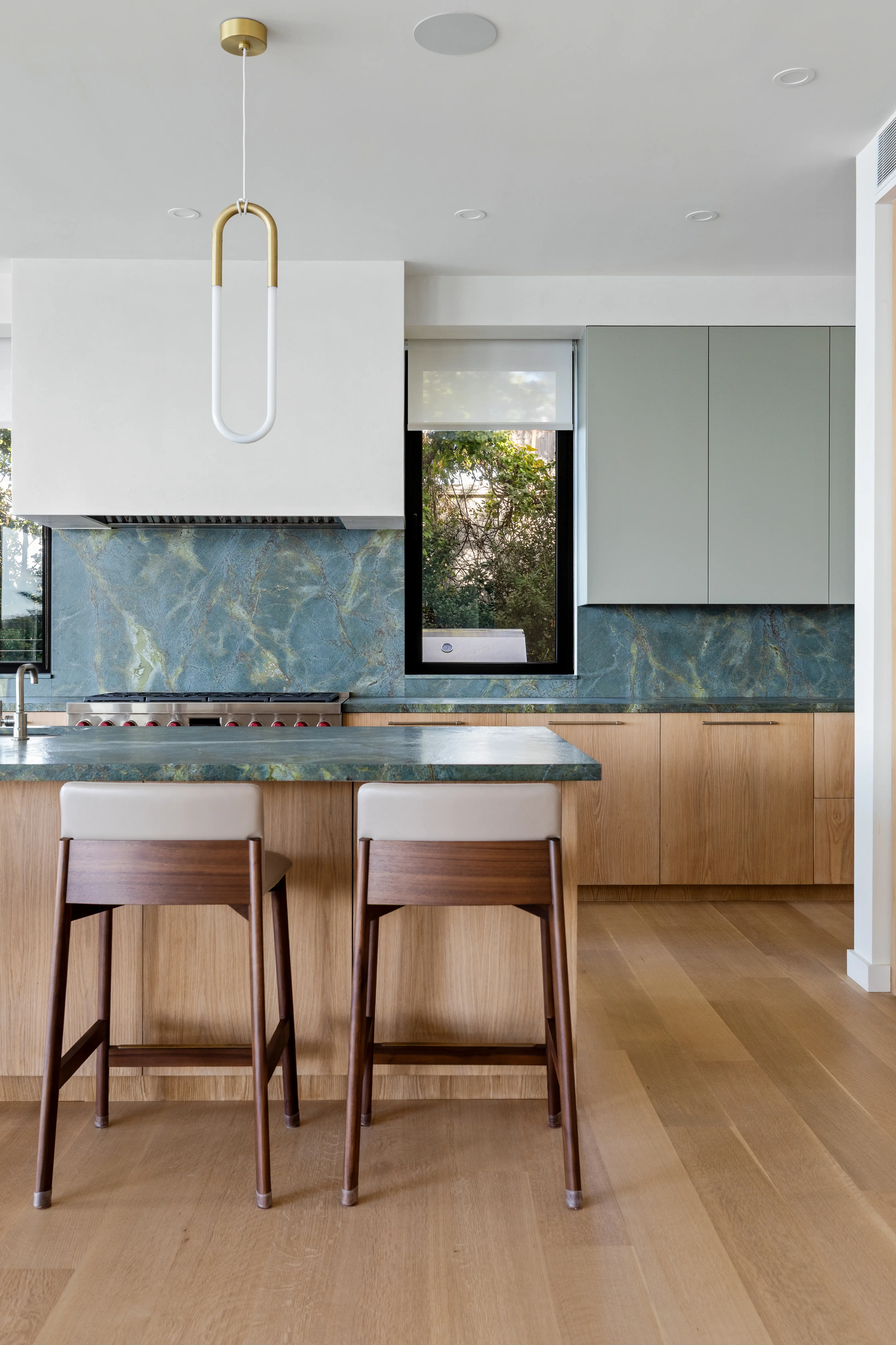 Modern luxury kitchen with marble countertops and custom wood cabinetry
