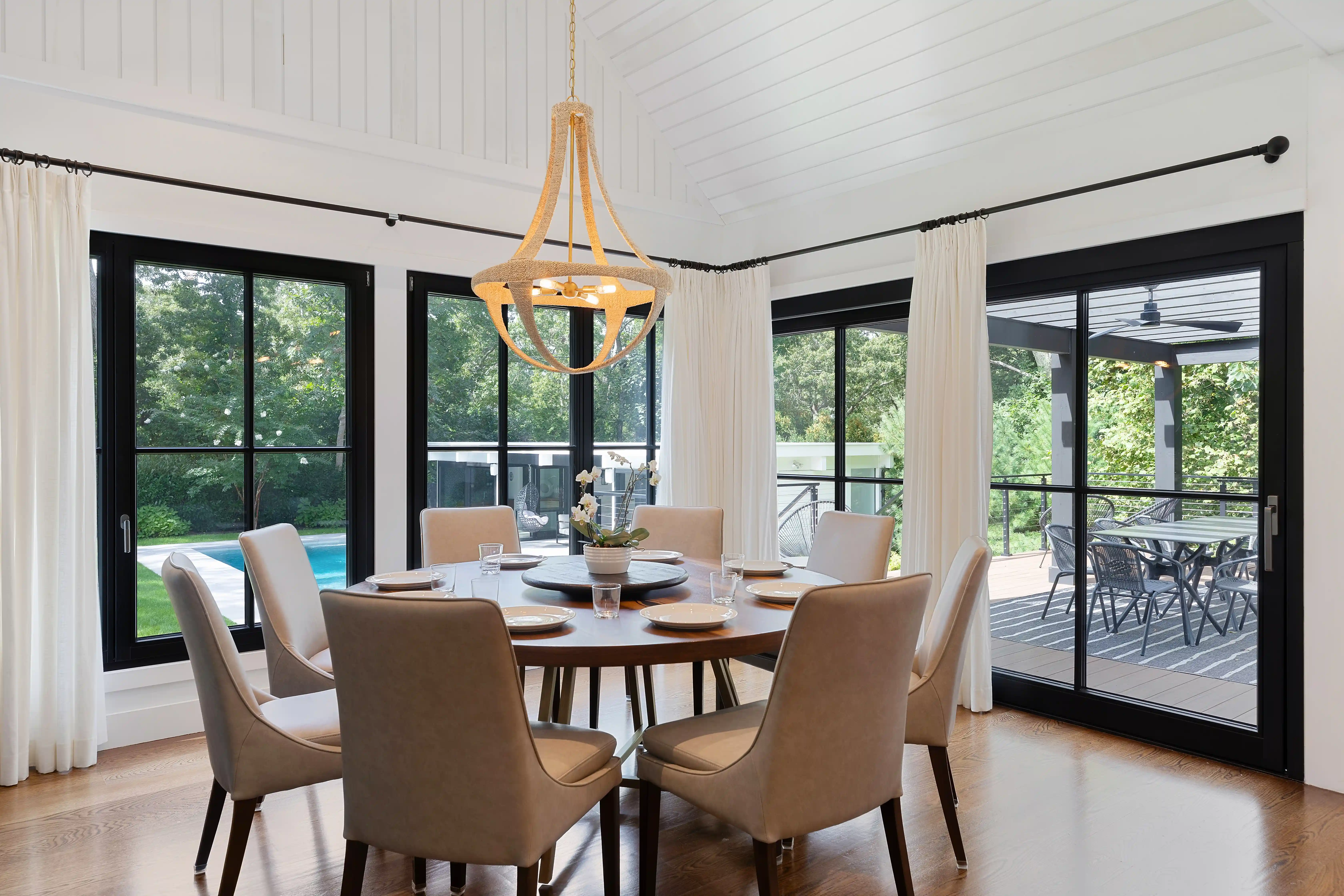 Modern dining room with large windows in a luxury custom-built home