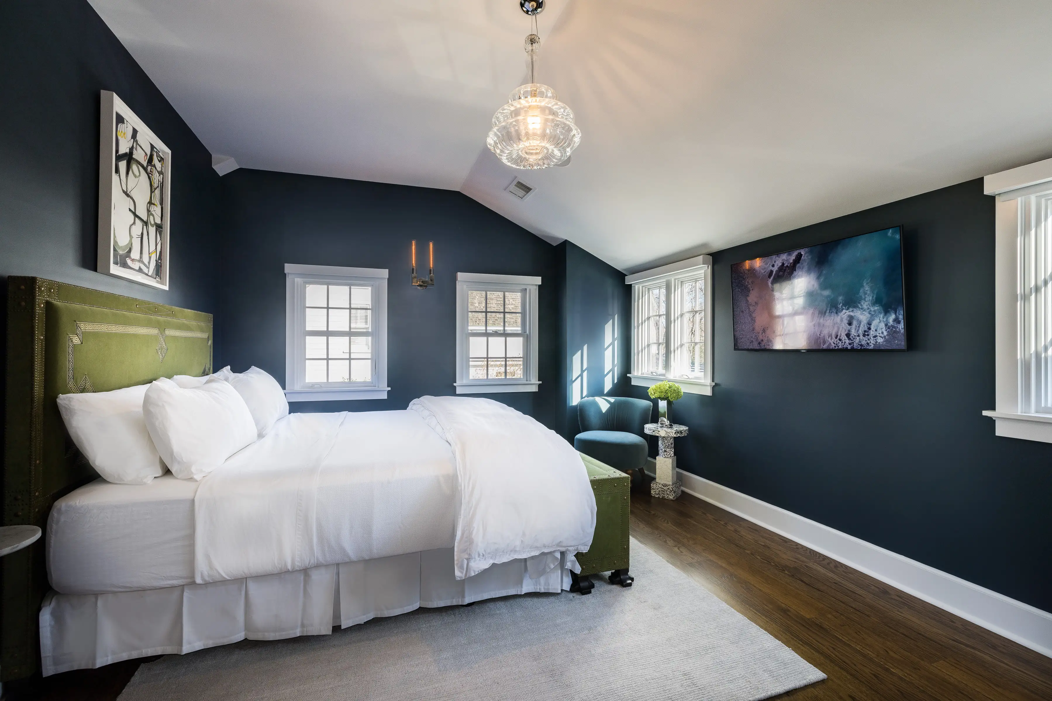 Modern luxury bedroom interior with dark accent walls and natural lighting