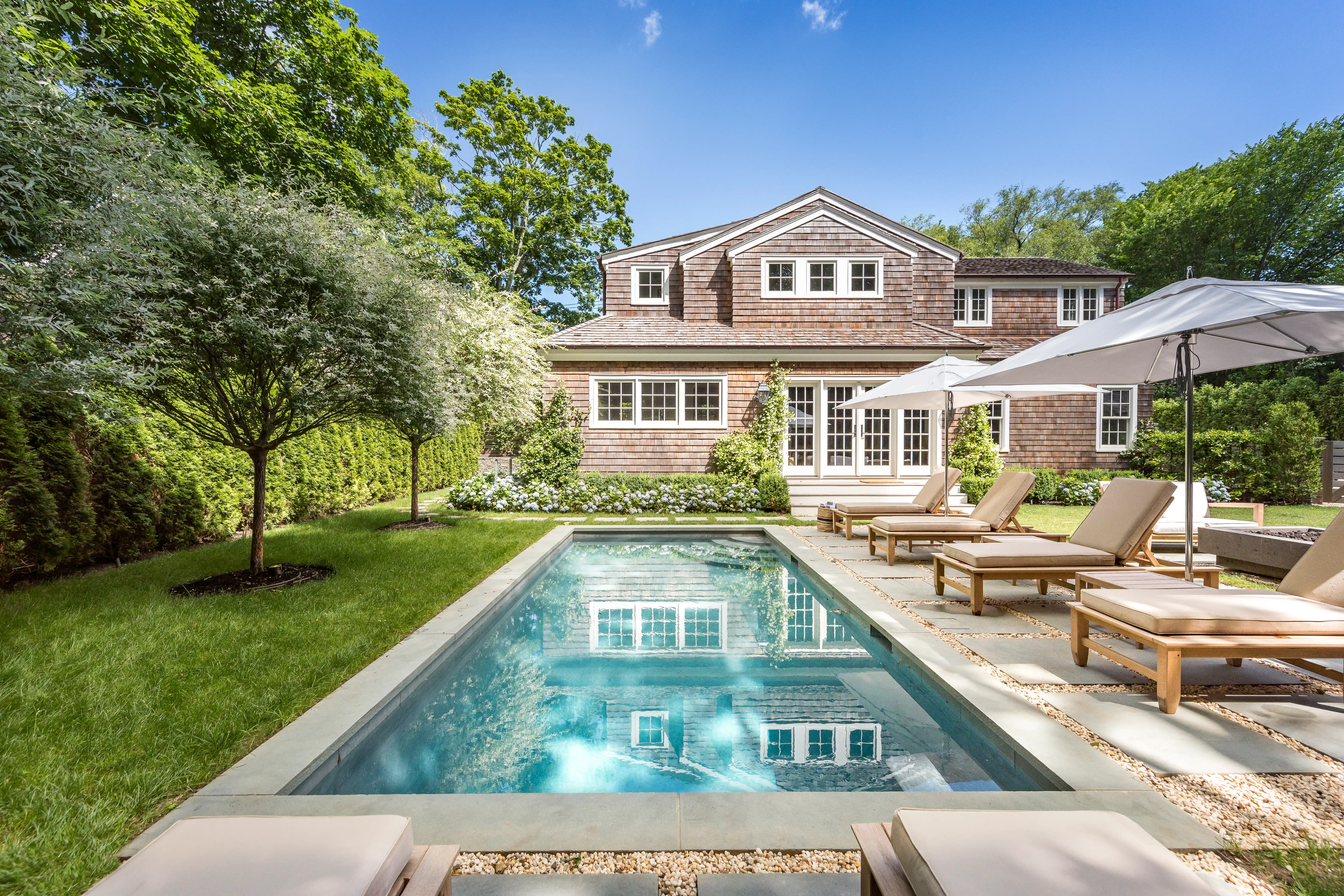 Luxury custom home with backyard swimming pool and outdoor lounge area