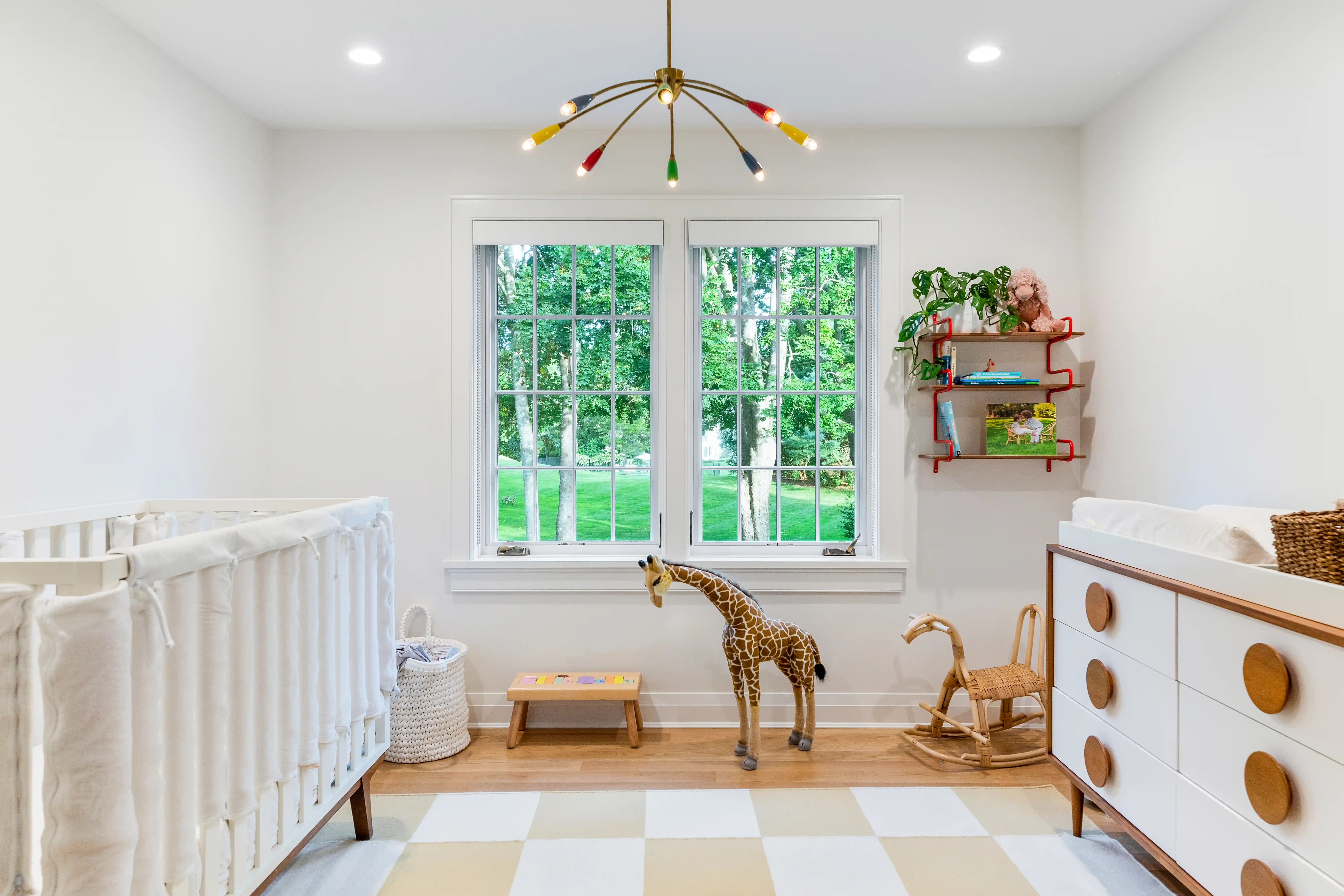 Nursery room design with large windows and modern custom home interiors