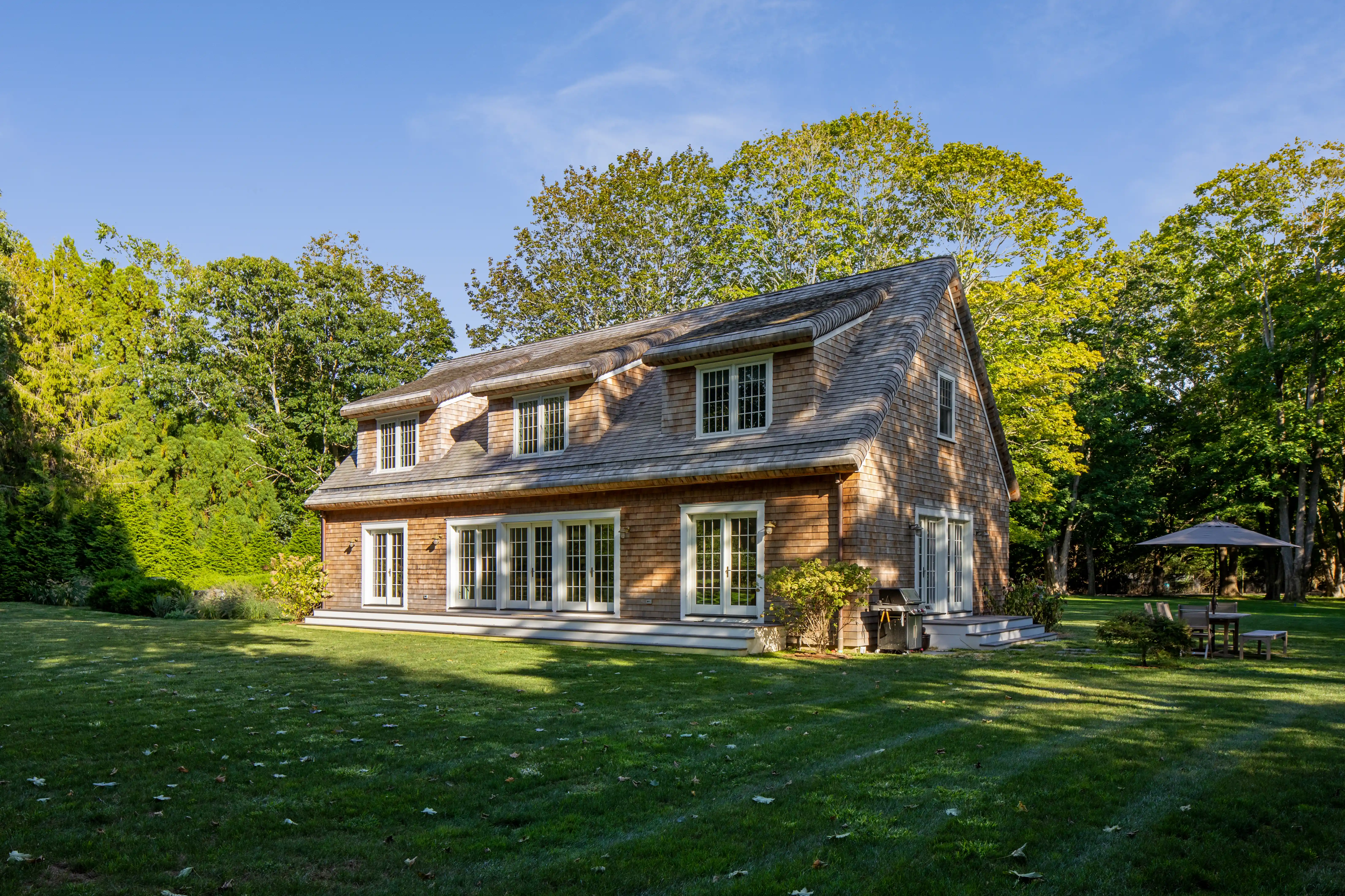 luxury home design with natural wood exterior and large backyard